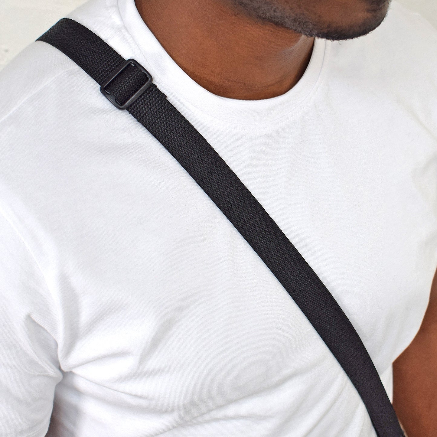 man wearing black 25mm shoulder strap