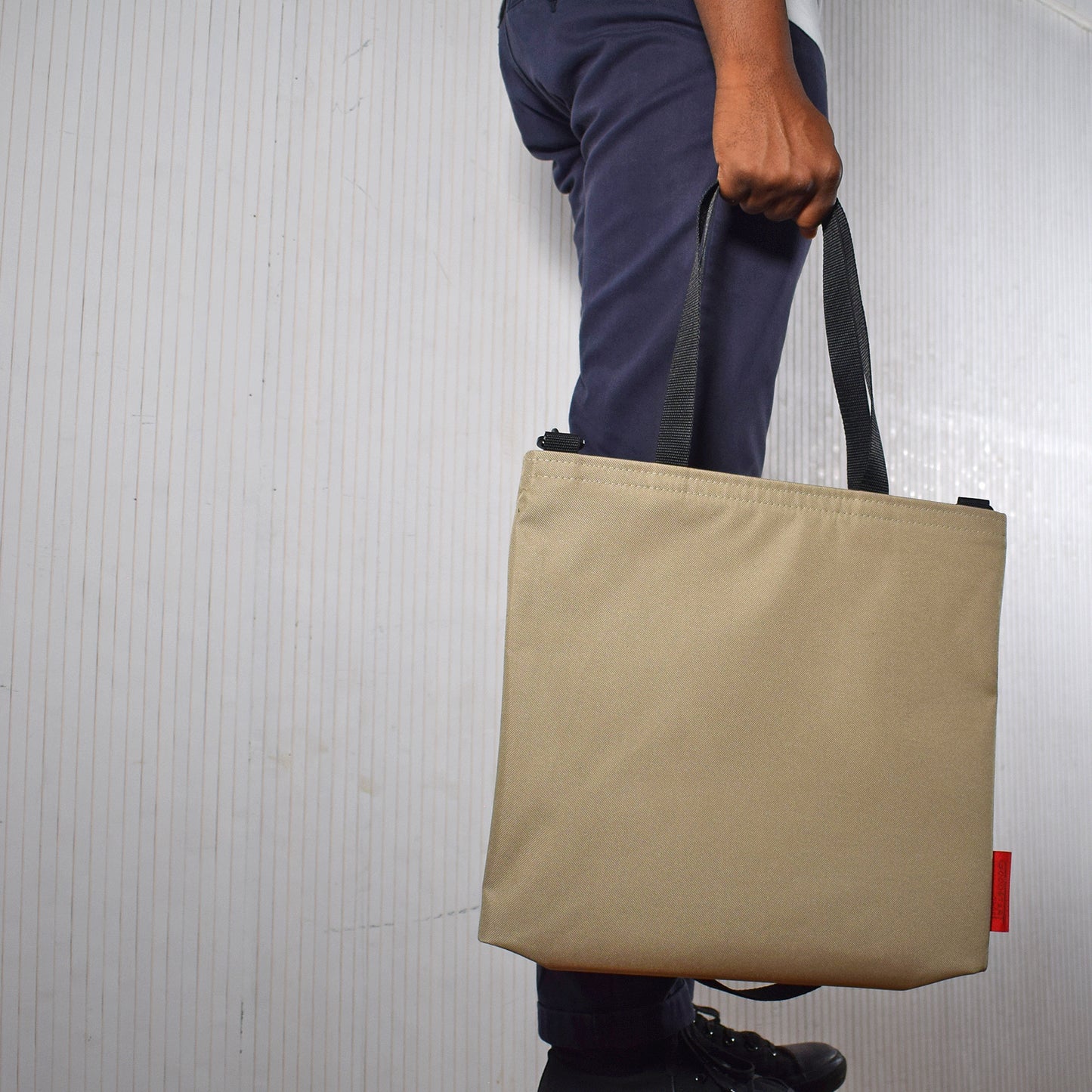 Model holding Sand colour tote bag no logo